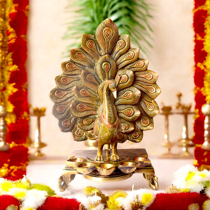 Satvik Stores Presents Stylish Peacock Panch Diya. Any festive occasion will be made wonderfully auspicious by the grace and beauty of the Peacock Brass Handcrafted Hanging Diya. Given that it was made by hand, the piece's abnormalities and flaws only serve to enhance Diya's allure and charisma.
