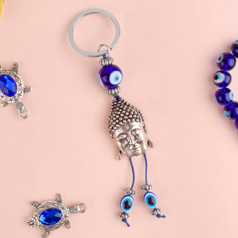 Alluring Silver Buddha Keychain with Evil Eye, a blend of spiritual protection and elegance, bringing peace and positivity into your life. Indiaβs Largest Pooja Accessories Brand β www.satvikstore.in