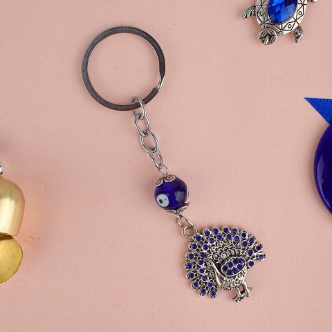 Aura Evil Eye Peacock Keychain β A stylish good luck and protective charm symbolizing grace and positivity. Indiaβs Largest Pooja Accessories Brand β www.satvikstore.in