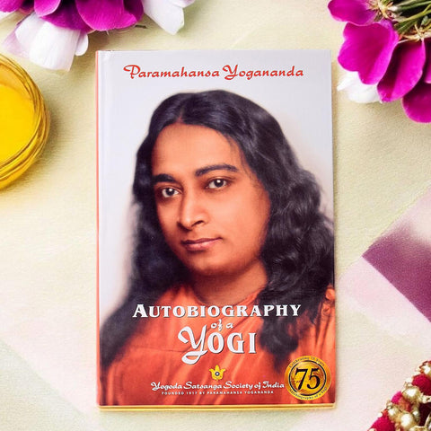 Cover of the book "Autobiography of a Yogi (Yogi Kathamrit)" by Paramahansa Yogananda, published by Self Realization Fellowship, featuring an image of the author. Indiaβs Largest Pooja Accessories Brand β www.satvikstore.in