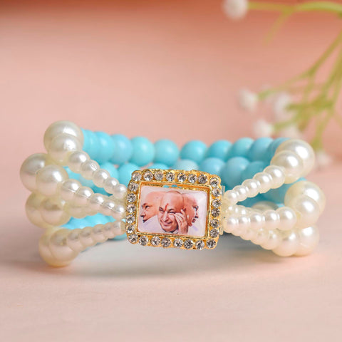 Baby Blue & White Pearl Four Layer Guruji Swaroop Bracelet featuring soft baby blue beads and luminous white pearls with Jai Guruji Swaroop β perfect for spiritual wear, festive gifting, and daily devotion. Indiaβs Largest Pooja Accessories Brand β www.satvikstore.in