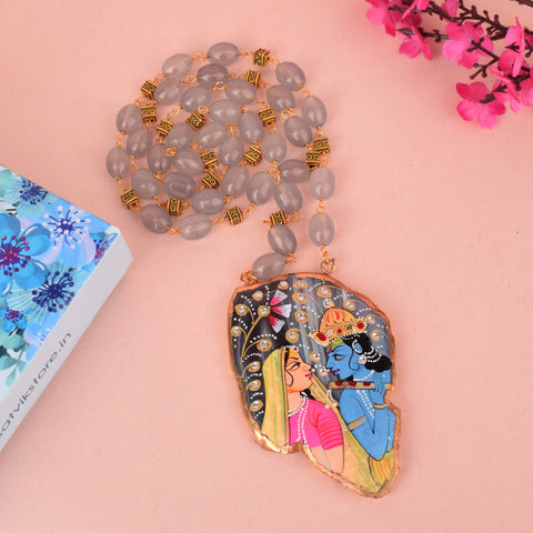 Beautifully hand-painted agate necklace featuring Lord Radha and Krishna, crafted with vibrant detailing on a natural semi-precious stone pendant. Indiaβs Largest Pooja Accessories Brand β www.satvikstore.in