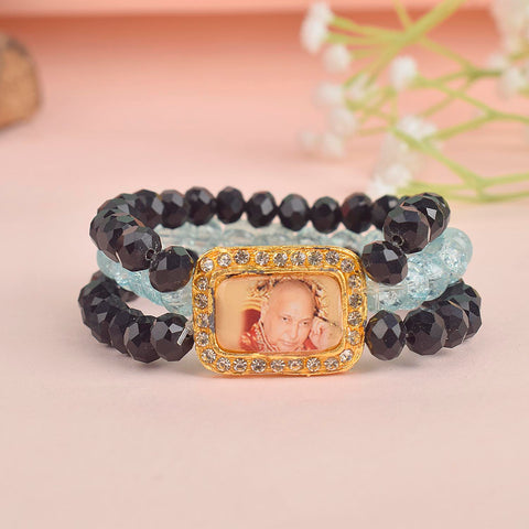 Black & Baby Blue Triple Layer Guruji Swaroop Bracelet featuring sleek black beads with soft baby blue middle layer and Jai Guruji Swaroop β perfect for spiritual wear, meditation, and gifting. Indiaβs Largest Pooja Accessories Brand β www.satvikstore.in