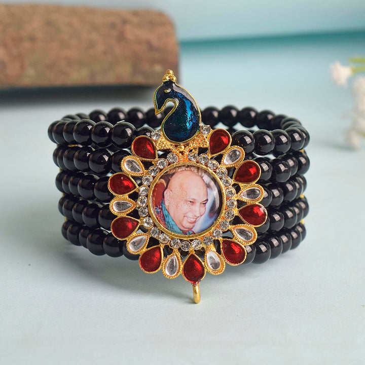 Black Beads Five Layer Guruji Swaroop Bracelet featuring a regal peacock-shaped pendant with Jai Guruji Swaroop β perfect for spiritual wear, meditation, and gifting. Indiaβs Largest Pooja Accessories Brand β www.satvikstore.in