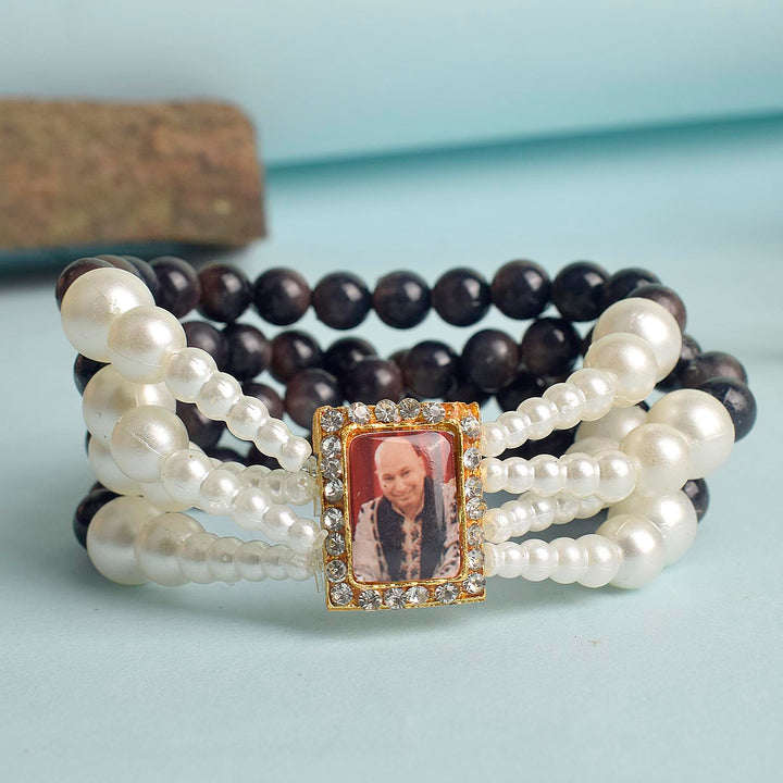 Black with White Pearl Four Layer Guruji Swaroop Bracelet featuring elegant black beads accented with luminous white pearls and Jai Guruji Swaroop β perfect for spiritual wear, festive gifting, and daily devotion. Indiaβs Largest Pooja Accessories Brand β www.satvikstore.in