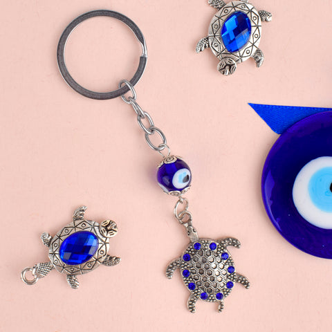 Blue Bead Silver Plated Evil Eye Turtle Keychain β A stylish and protective keychain with blue beads and an evil eye charm, perfect for your bike or car. Indiaβs Largest Pooja Accessories Brand β www.satvikstore.in