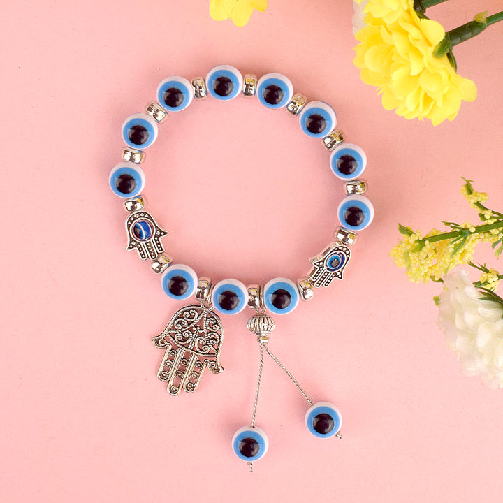 Blue Evil Eye Bracelet with Hamza Hand for Girls and Women, featuring an evil eye charm and Hamza hand for protection and style. Indiaβs Largest Pooja Accessories Brand β www.satvikstore.in