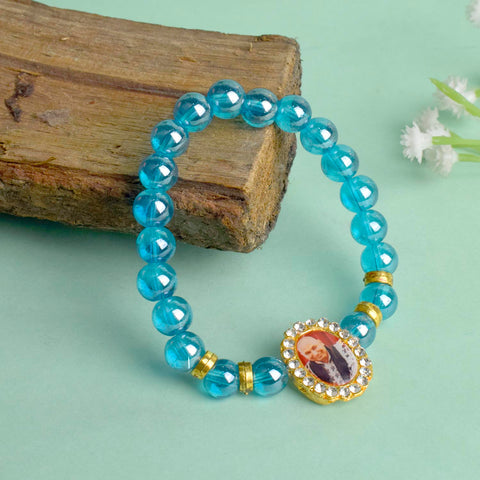 Blue Shiny Beads Single Layer Guruji Swaroop Bracelet featuring sparkling blue beads and Jai Guruji Swaroop β perfect for minimalist spiritual wear, meditation, and gifting. Indiaβs Largest Pooja Accessories Brand β www.satvikstore.in