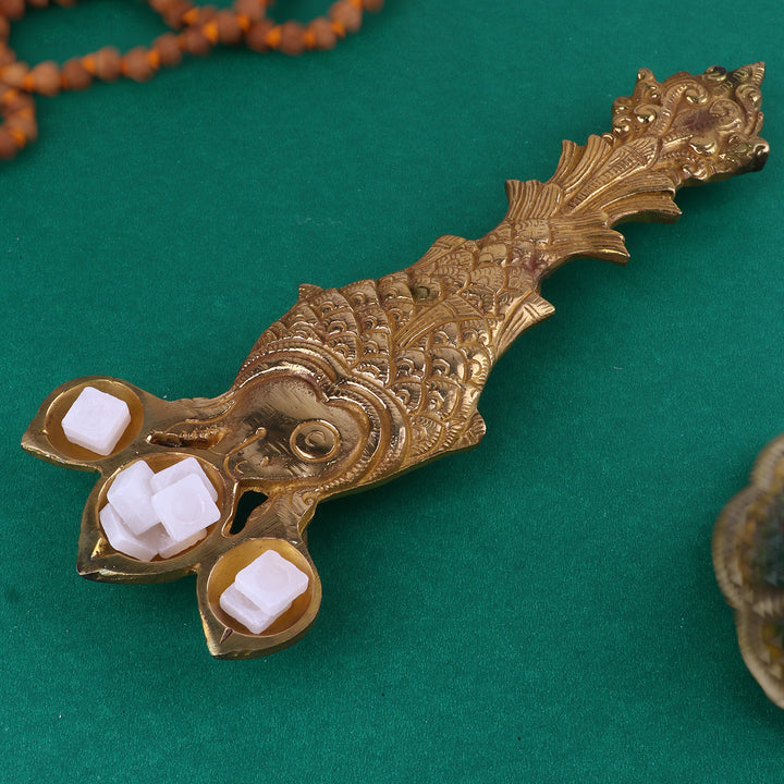 Designer Brass Fish Shape Trimukh Kapoor Aarti Spoon, a beautifully crafted brass spoon in a fish shape, featuring a Trimukh design, used for performing aarti with Kapoor (camphor) during pooja and spiritual rituals. 
India’s Largest Pooja Accessories Brand – www.satvikstore.in