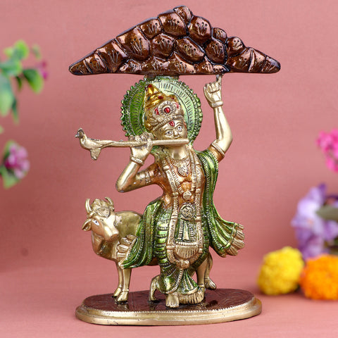 3.9 Inch intricately crafted Brass Krishna Idol depicting Lord Krishna lifting Mount Govardhan with one hand, symbolizing divine protection and strength, ideal for spiritual home dΓ©cor and devotional worship.  No.1 Brass Idol Store www.satvikstore.in
