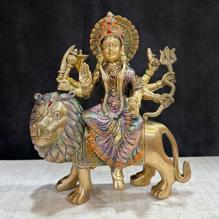Embrace the powerful energy of Maa Durga with this 9-inch Brass 8-Armed Durga Idol, beautifully depicted riding her mighty lion. This meticulously crafted statue showcases Maa Durga in her most majestic form, symbolizing strength, courage, and divine protection. No.1 Brass Idol Store www.satvikstore.in