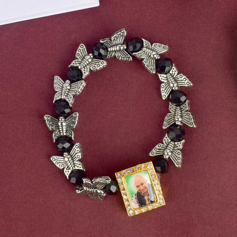 Chic Guruji Swaroop Bracelet featuring black beads and silver butterfly charms, handcrafted for spiritual elegance and daily devotion. Indiaβs Largest Pooja Accessories Brand β www.satvikstore.in