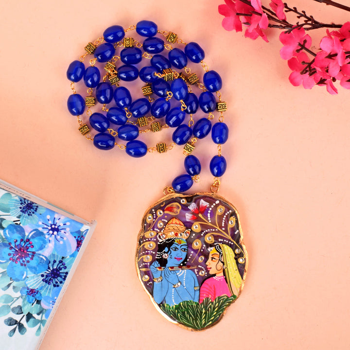 Close-up image of a hand-painted Agate Radha Krishna necklace featuring vibrant colors and detailed craftsmanship, showcasing divine Radha Krishna motifs on a natural agate pendant. India’s Largest Pooja Accessories Brand – www.satvikstore.in