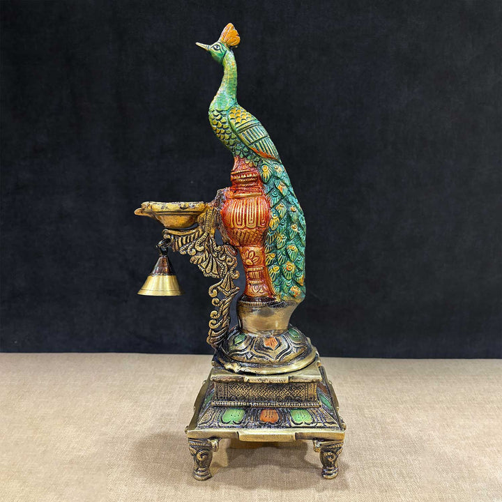 Colorful Brass Peacock Diya Stand with intricate detailing, showcasing a vibrant peacock perched gracefully above multiple diya holders, ideal for festive décor and traditional worship settings. India’s Largest Pooja Accessories Brand – www.satvikstore.in