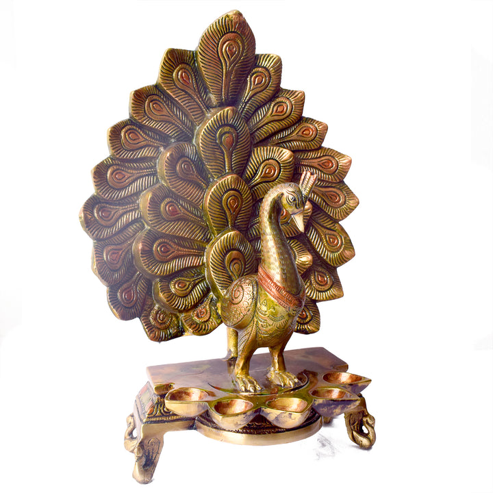 Satvik Stores Presents Stylish Peacock Panch Diya. Any festive occasion will be made wonderfully auspicious by the grace and beauty of the Peacock Brass Handcrafted Hanging Diya. Given that it was made by hand, the piece's abnormalities and flaws only serve to enhance Diya's allure and charisma.