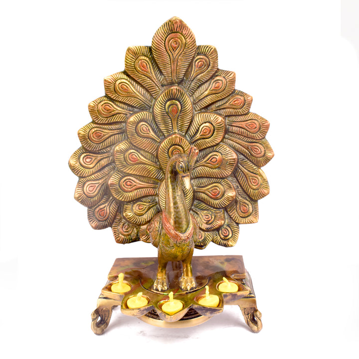 Satvik Stores Presents Stylish Peacock Panch Diya. Any festive occasion will be made wonderfully auspicious by the grace and beauty of the Peacock Brass Handcrafted Hanging Diya. Given that it was made by hand, the piece's abnormalities and flaws only serve to enhance Diya's allure and charisma.
