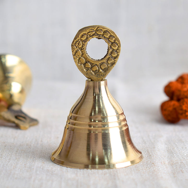 Elegant brass pooja bell with intricate design, symbolizing spiritual harmony and traditionally used during Hindu rituals and temple ceremonies. India’s Largest Pooja Accessories Brand – www.satvikstore.in