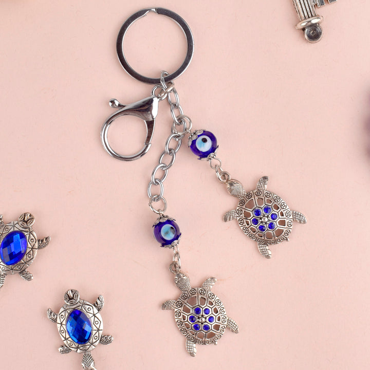 Evil Eye 2 Tier Turtle Metal Keychain β A Feng Shui good luck charm symbolizing longevity, stability, and protection. Indiaβs Largest Pooja Accessories Brand β www.satvikstore.in