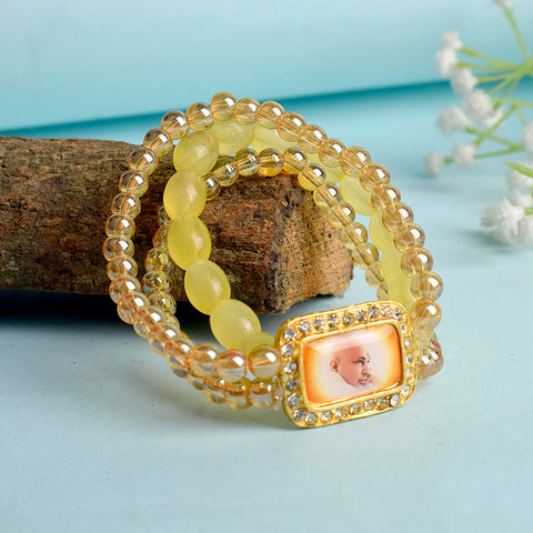 Golden Clear & Yellow Triple Layer Guruji Swaroop Bracelet featuring sparkling golden clear beads with bright yellow middle layer and Jai Guruji Swaroop β perfect for spiritual wear, meditation, and gifting. Indiaβs Largest Pooja Accessories Brand β www.satvikstore.in