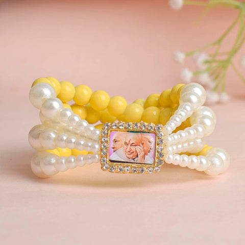 Pale Yellow with White Pearl Four Layer Guruji Swaroop Bracelet featuring soft pale yellow beads and radiant white pearls with Jai Guruji Swaroop β perfect for spiritual wear, festive gifting, and daily devotion. Indiaβs Largest Pooja Accessories Brand β www.satvikstore.in