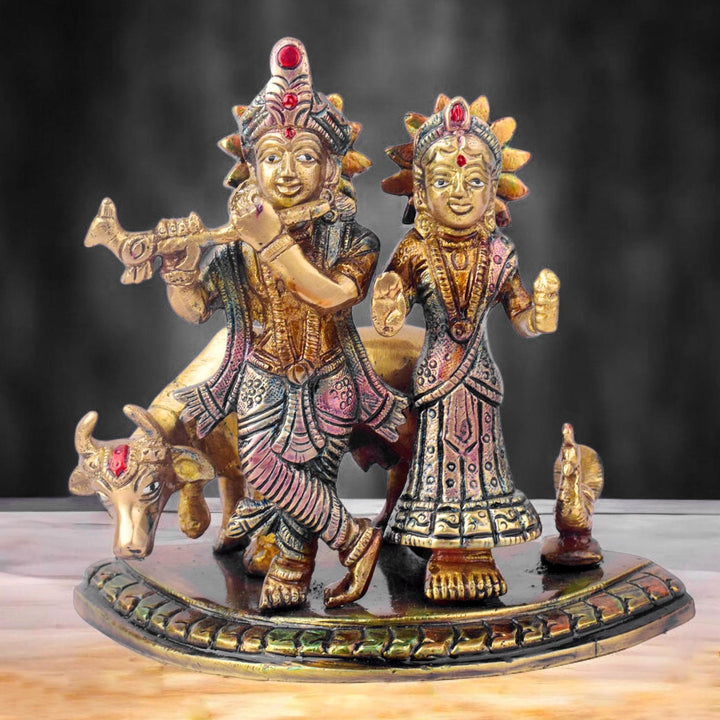 The 5.5 Inch Divine Radha Krishna with Kamdhenu Cow Idol is a captivating symbol of eternal love, harmony, and divine blessings. This beautifully crafted idol features Radha and Krishna in a serene pose, with Krishna playing his mesmerizing flute and Radha standing gracefully by his side.