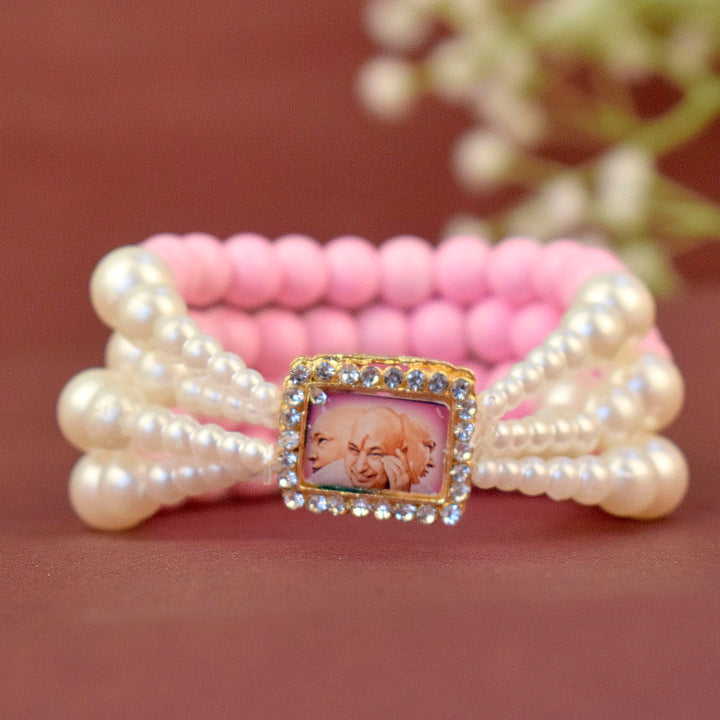 Pink & White Pearl Four Layer Guruji Swaroop Bracelet featuring delicate pink beads and luminous white pearls with Jai Guruji Swaroop β perfect for spiritual wear, festive gifting, and daily devotion. Indiaβs Largest Pooja Accessories Brand β www.satvikstore.in