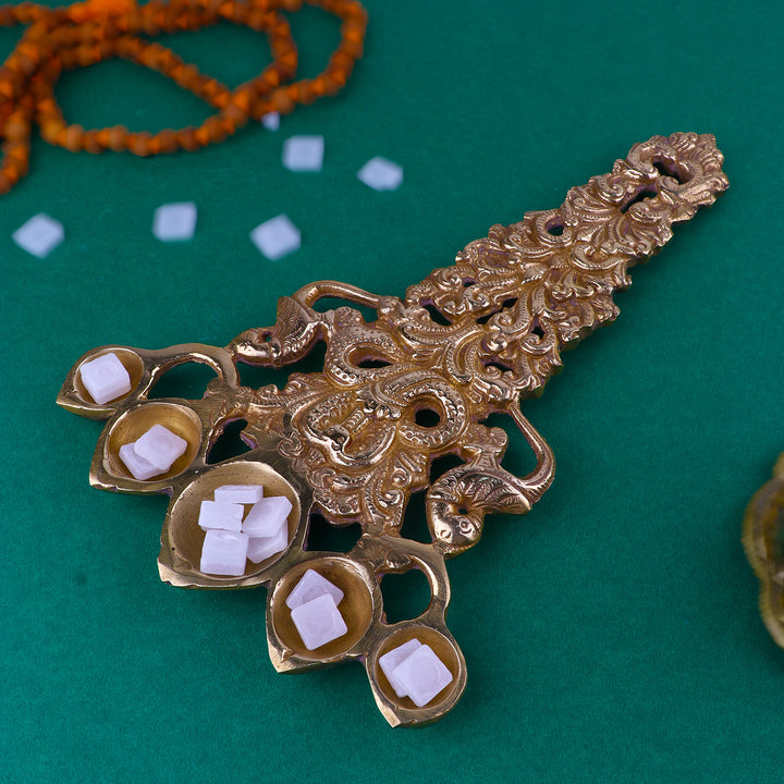 Pure Brass Designer Pooja Aarti Panchmukhi Spoon, an intricately designed brass spoon featuring the Panchmukhi (five-faced) motif, used for performing aarti during pooja and spiritual rituals. 
India’s Largest Pooja Accessories Brand – www.satvikstore.in