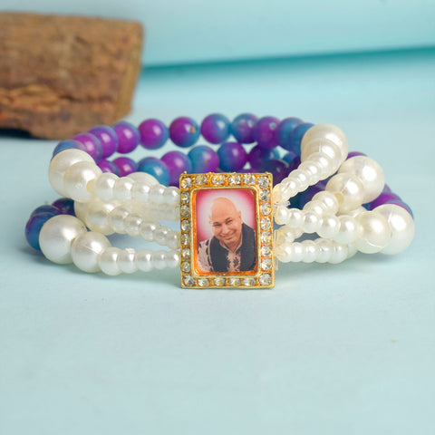 Purple & Blue with White Pearl Four Layer Guruji Swaroop Bracelet featuring rich purple and blue beads accented with luminous white pearls and Jai Guruji Swaroop β perfect for spiritual wear, festive gifting, and daily devotion. Indiaβs Largest Pooja Accessories Brand β www.satvikstore.in