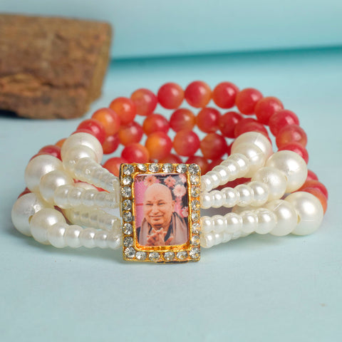 Red & White Pearl Four Layer Guruji Swaroop Bracelet featuring vibrant red beads and luminous white pearls with Jai Guruji Swaroop β perfect for spiritual wear, festive gifting, and daily devotion. Indiaβs Largest Pooja Accessories Brand β www.satvikstore.in