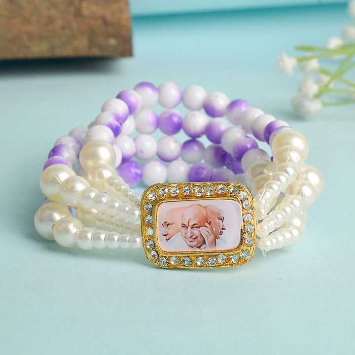 White & Lilac with White Pearl Four Layer Guruji Swaroop Bracelet featuring soft lilac beads, elegant white beads, and luminous white pearls with Jai Guruji Swaroop β perfect for spiritual wear, festive gifting, and daily devotion. Indiaβs Largest Pooja Accessories Brand β www.satvikstore.in