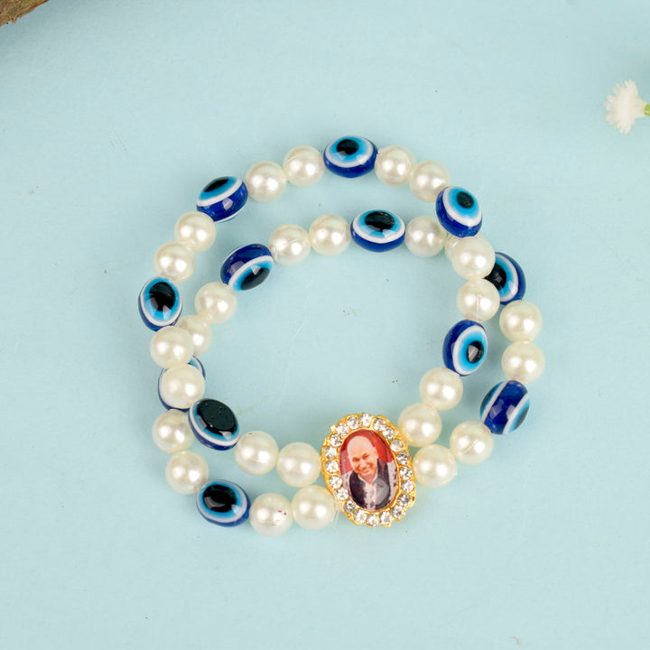 White Pearl with Evil Eye Double Layer Guruji Swaroop Bracelet featuring luminous pearls and a protective blue evil eye bead with Jai Guruji Swaroop β perfect for spiritual wear, protection, and gifting. Indiaβs Largest Pooja Accessories Brand β www.satvikstore.in