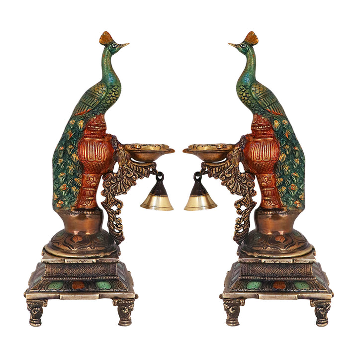 Satvik Stores Presents Brass Peacock Diya Stand. Any festive occasion will be made wonderfully auspicious by the grace and beauty of the Peacock Brass Handcrafted Hanging Diya. Given that it was made by hand, the piece's abnormalities and flaws only serve to enhance Diya's allure and charisma.