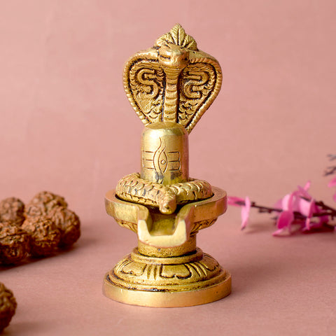 Elegant Brass Shivling with coiled Nag, symbolizing spiritual energy and protection, perfect for home worship and meditation. Indiaβs Largest Pooja Accessories Brand β www.satvikstore.in