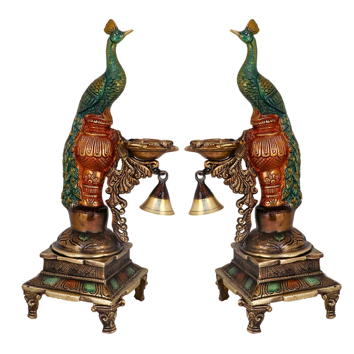 Satvik Stores Presents Brass Peacock Diya Stand. Any festive occasion will be made wonderfully auspicious by the grace and beauty of the Peacock Brass Handcrafted Hanging Diya. Given that it was made by hand, the piece's abnormalities and flaws only serve to enhance Diya's allure and charisma.