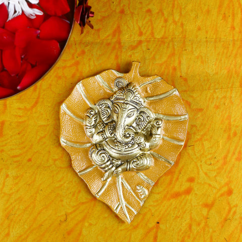Yellow wall hanging featuring Lord Ganesh intricately crafted on a leaf-shaped patta, ideal for home temple or spiritual dΓ©cor. Indiaβs Largest Pooja Accessories Brand β www.satvikstore.in