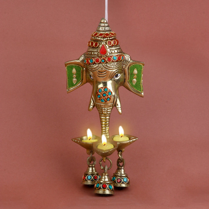 9.2 Inch Brass Ganesh Face Wall Hanging featuring intricate stone work and a hanging bell perfect for entrance décor, Vastu, and spiritual ambiance. No.1 Brass Idol Store www.satvikstore.in 

