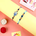Elegant Rakhi pair with decorative beadwork for brothers. India’s Largest Pooja Accessories Brand – www.satvikstore.in
